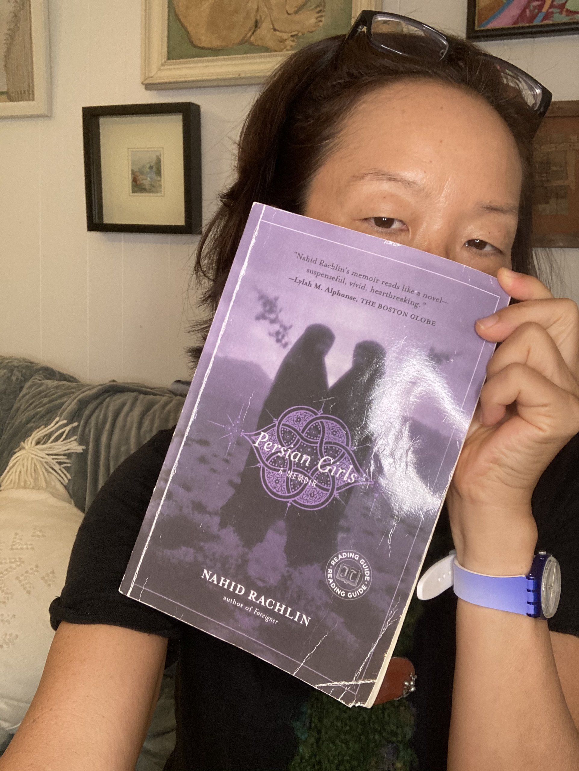 Dr. Stephanie Han holding a copy of Nahid Rachlin's Persian Girls